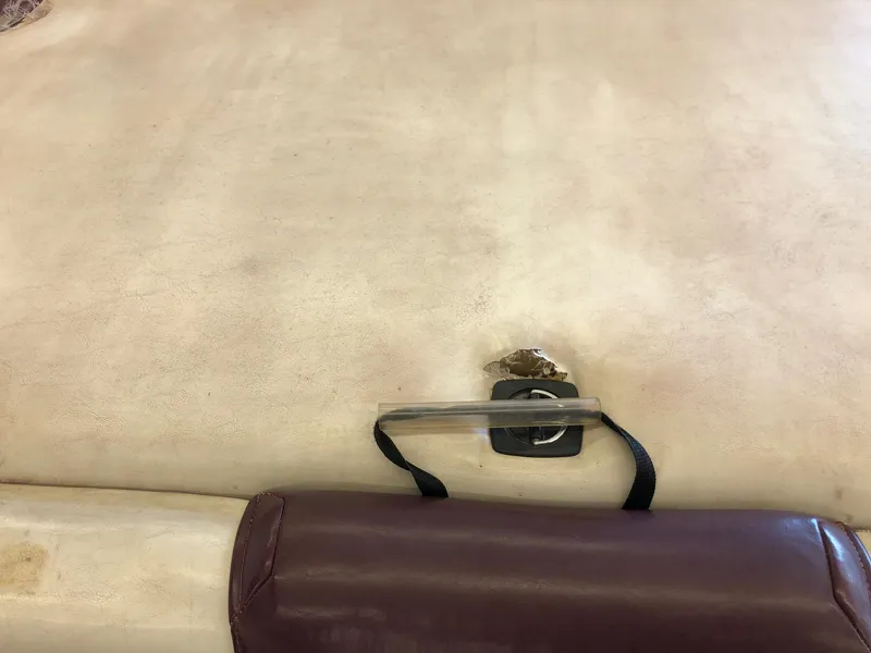 Slide: The Image of Damaged seat upholstery on a 1992 Four Winns 220 Horizon Open Bow boat. - 21