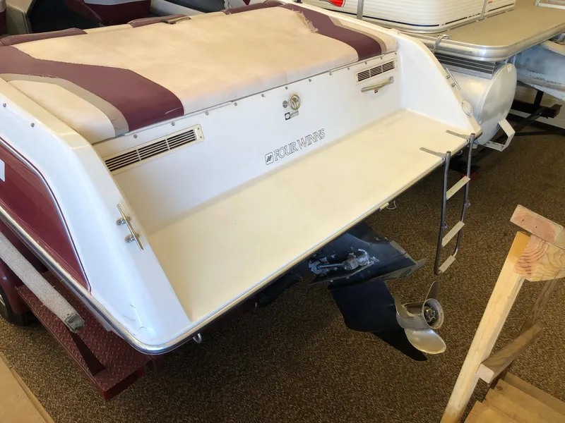 Slide: The Image of 1992 Four Winns 220 Horizon Open Bow boat rear view with swim platform and ladder. - 23