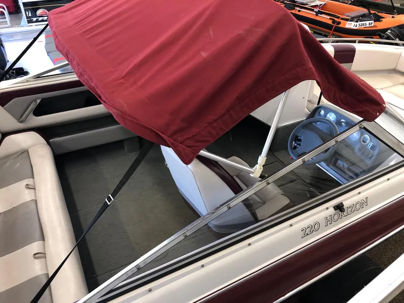 Slide: The Image of 1992 Four Winns 220 Horizon Open Bow boat with red canopy and beige interior. - 3