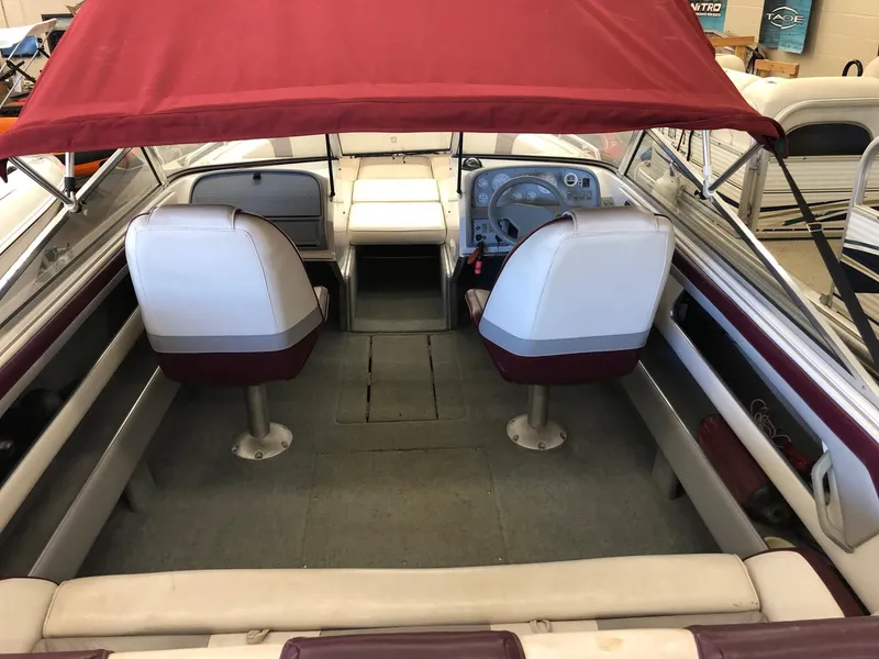 Slide: The Image of 1992 Four Winns 220 Horizon Open Bow boat interior with red canopy and white seats. - 4