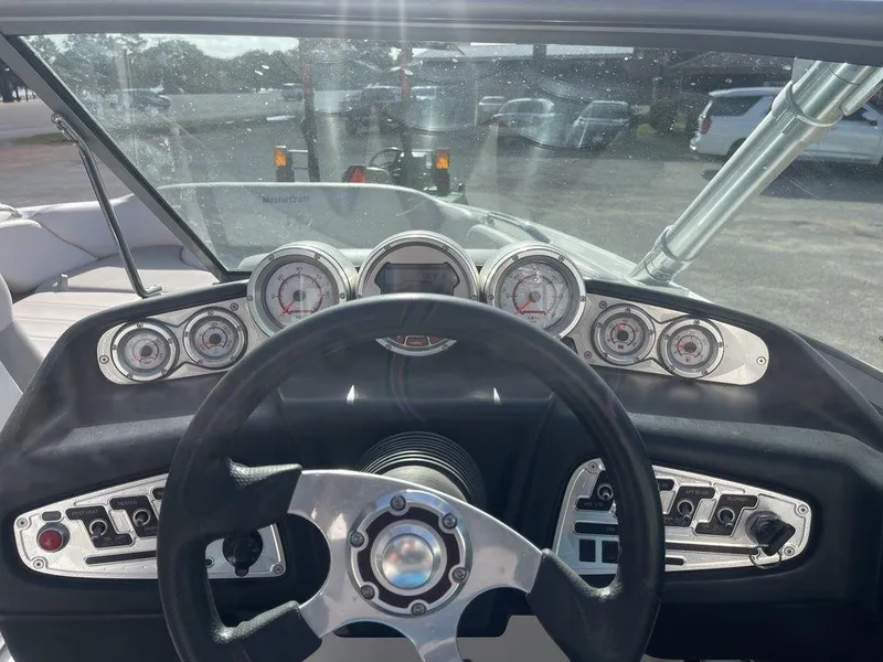 Slide: The Image of 2008 MasterCraft X45 boat dashboard with steering wheel and gauges. - 13