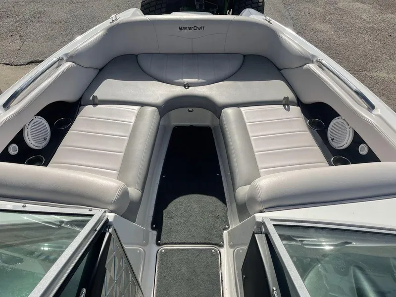 Slide: The Image of 2008 MasterCraft X45 boat interior with gray seating and built-in speakers. - 8