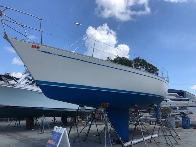 Slide: The Image of 1981 Nautor Swan 371 Sloop on stands, blue and white hull, clear sky background. - 1