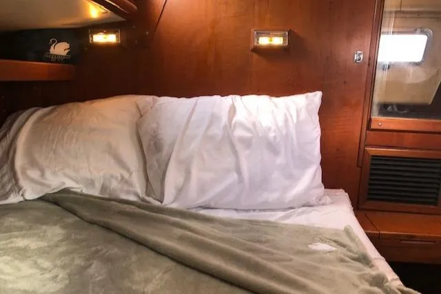 Slide: The Image of Cozy cabin interior of 1981 Nautor Swan 371 Sloop with wooden paneling and soft bedding. - 10