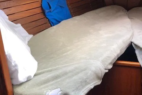 Slide: The Image of Cozy cabin interior of 1981 Nautor Swan 371 Sloop with wooden paneling and bedding. - 11