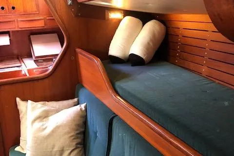 Slide: The Image of Interior of 1981 Nautor Swan 371 Sloop with wooden cabin and cozy bedding. - 13