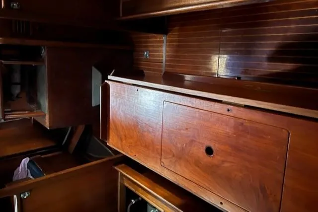 Slide: The Image of Interior of 1981 Nautor Swan 371 Sloop with wooden cabinetry and storage compartments. - 14