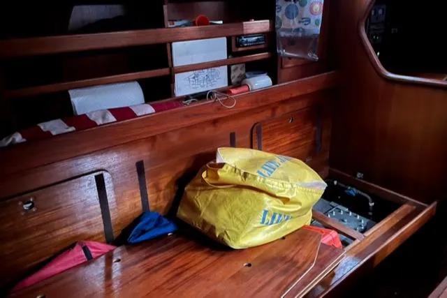 Slide: The Image of Interior of 1981 Nautor Swan 371 Sloop with wooden finish and storage area. - 15