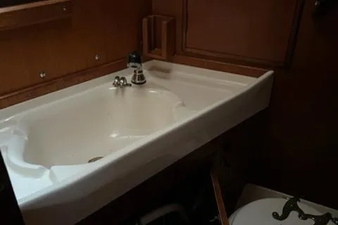 Slide: The Image of Interior of 1981 Nautor Swan 371 Sloop, featuring a compact bathroom sink. - 18