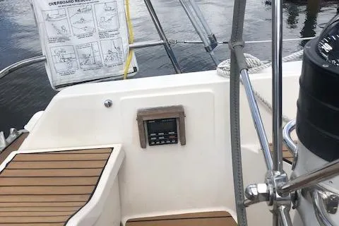 Slide: The Image of 1981 Nautor Swan 371 Sloop cockpit with wooden seating and navigation equipment. - 24