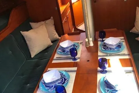 Slide: The Image of Interior of 1981 Nautor Swan 371 Sloop with elegant dining setup and cozy seating. - 3
