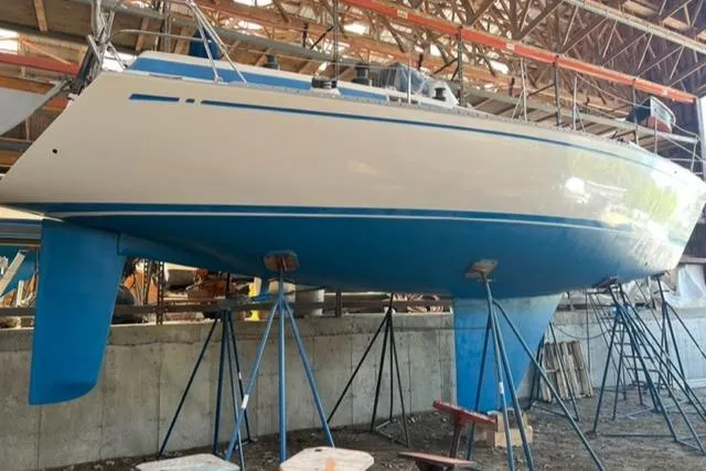 Slide: The Image of 1981 Nautor Swan 371 Sloop in dry dock, showcasing sleek hull design. - 39
