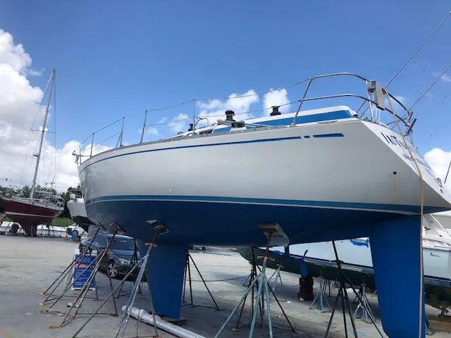 Slide: The Image of 1981 Nautor Swan 371 Sloop sailboat on stands, clear sky background. - 47