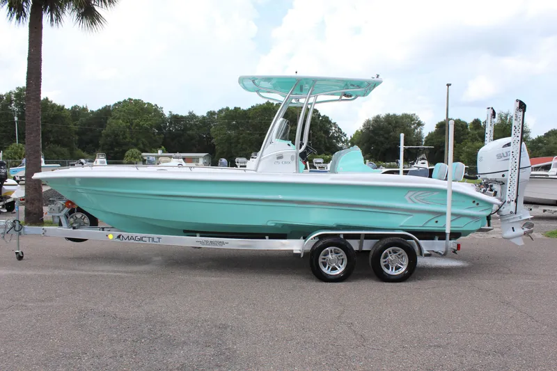 The Image of 2022 ALK2 Powerboats 25 CRX on trailer, mint green hull, parked outdoors. - 1