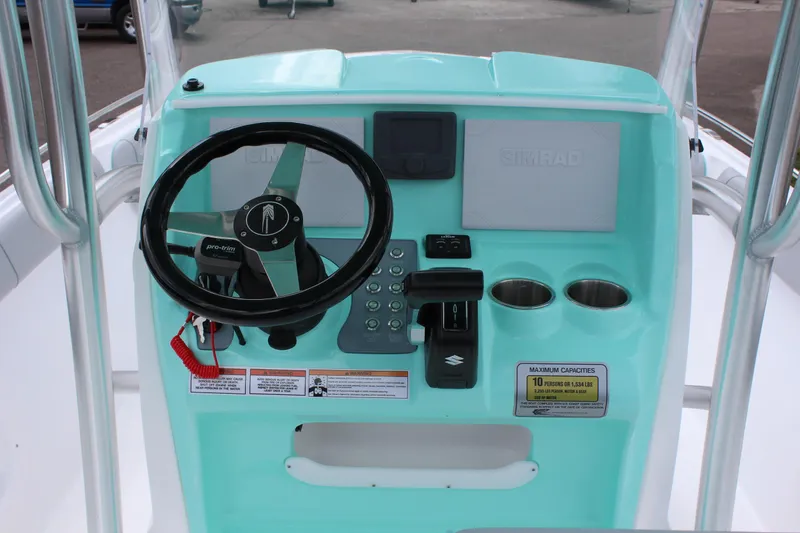 Slide: The Image of 2022 ALK2 Powerboats 25 CRX helm with steering wheel, controls, and cup holders. - 12