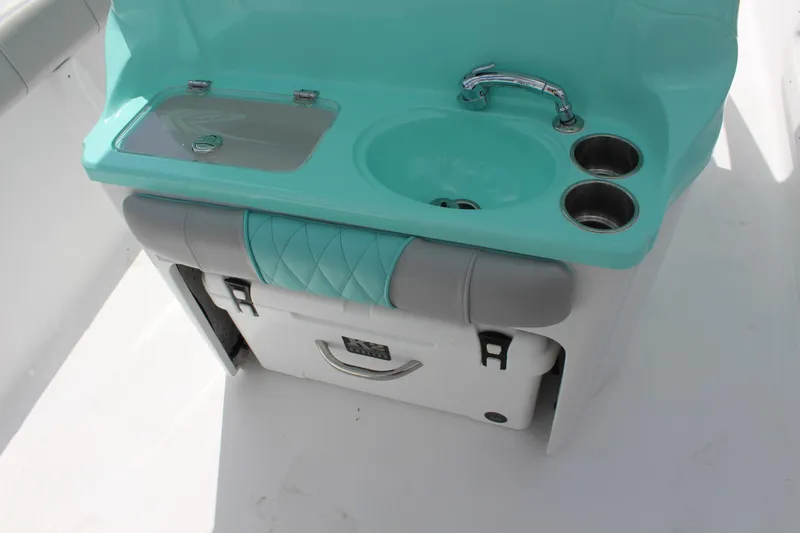 Slide: The Image of 2022 ALK2 Powerboats 25 CRX boat sink and storage area with teal accents. - 24