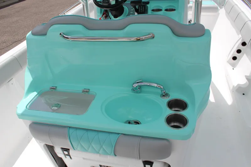 Slide: The Image of 2022 ALK2 Powerboats 25 CRX interior with turquoise sink and storage compartments. - 25