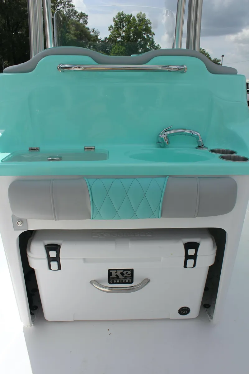 Slide: The Image of 2022 ALK2 Powerboats 25 CRX with teal console and built-in cooler. - 30