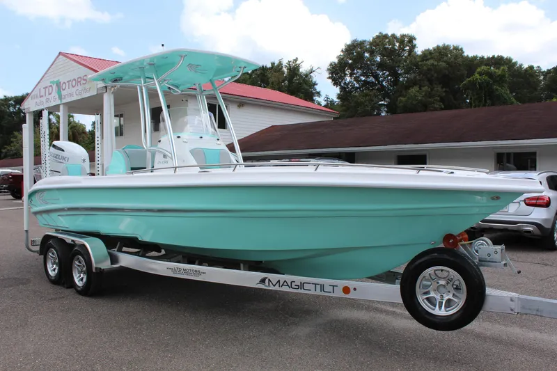 Slide: The Image of 2022 ALK2 Powerboats 25 CRX on trailer, mint green hull, parked outside dealership. - 5