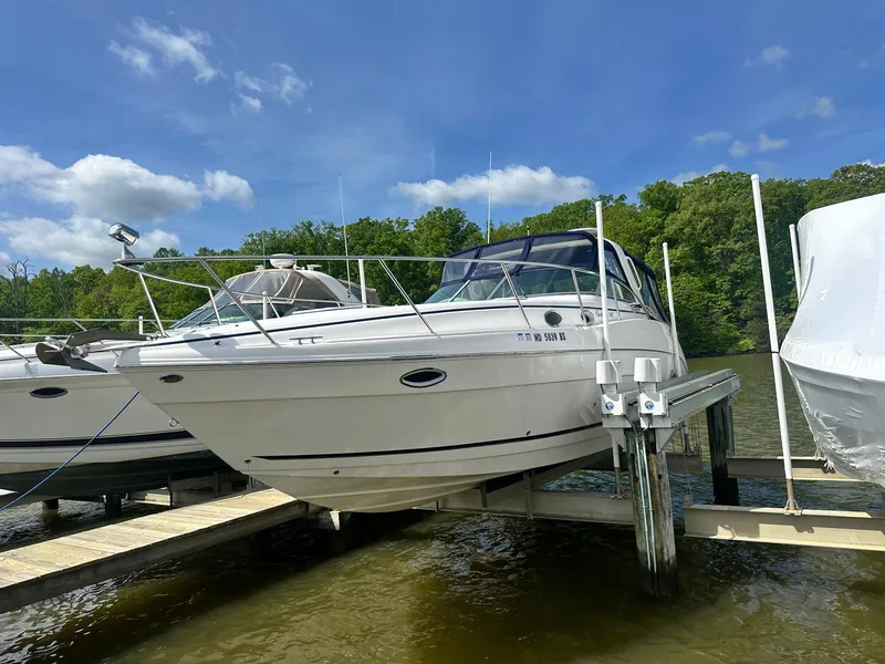 Slide: The Image of 2004 Rinker 342 Express Cruiser docked on a sunny day. - 2