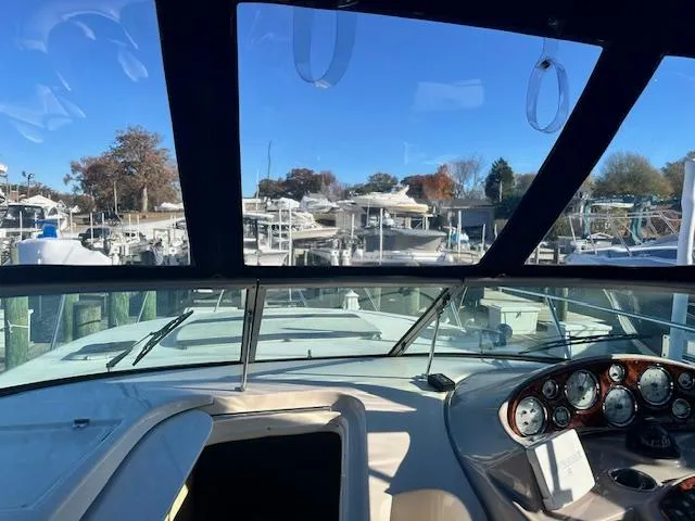 Slide: The Image of 2004 Rinker 342 Express Cruiser cockpit view with marina background. - 21