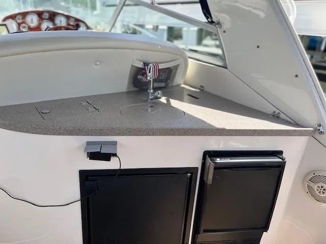 Slide: The Image of 2004 Rinker 342 Express Cruiser interior with kitchenette and control panel. - 22