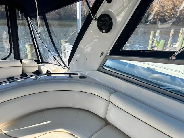 Slide: The Image of Interior of 2004 Rinker 342 Express Cruiser with white seating and window view. - 26