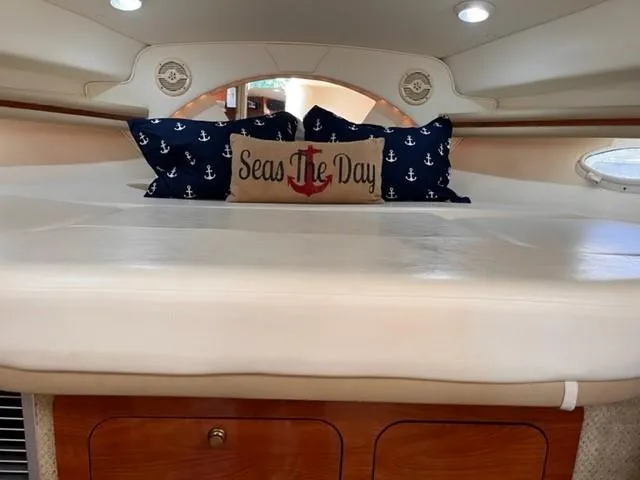 Slide: The Image of 2004 Rinker 342 Express Cruiser cabin with nautical pillows and "Seas The Day" decor. - 30