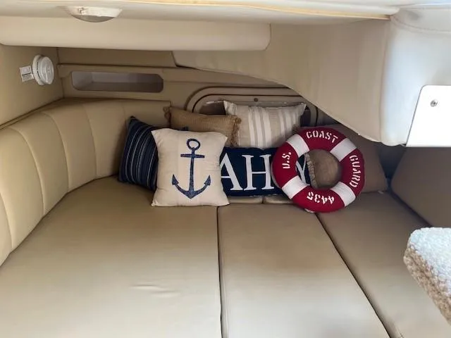 Slide: The Image of 2004 Rinker 342 Express Cruiser cabin with nautical-themed pillows and decor. - 32