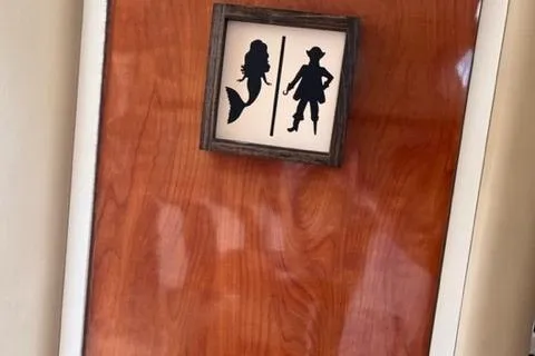 Slide: The Image of Wooden door with mermaid and pirate silhouettes, Rinker 342 Express Cruiser, 2004 model. - 36