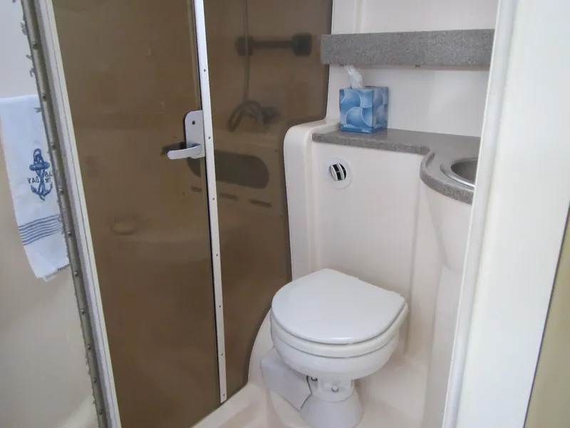 Slide: The Image of 2004 Rinker 342 Express Cruiser bathroom with shower, toilet, and sink. - 40