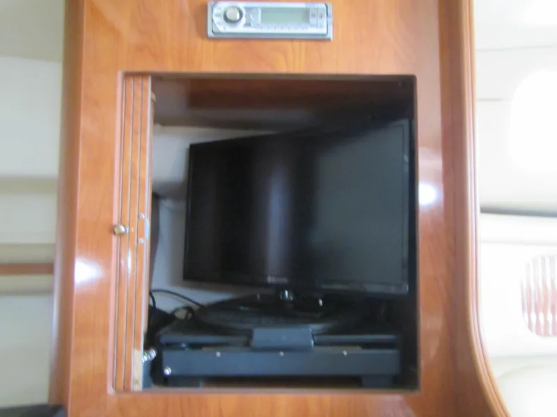 Slide: The Image of 2004 Rinker 342 Express Cruiser interior with TV and stereo system. - 45