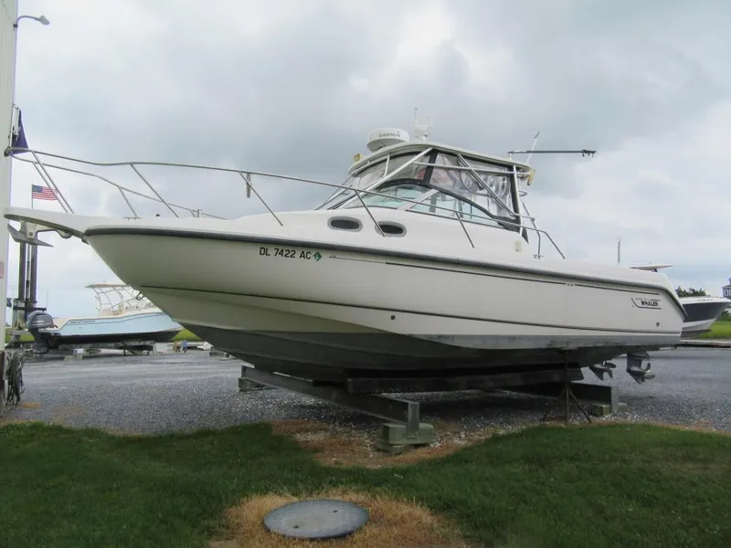 The Image of 2002 Boston Whaler 295 Conquest boat on a trailer, side view. - 1