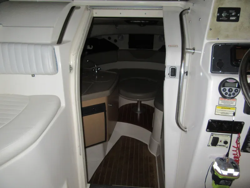 Slide: The Image of Interior cabin of a 2002 Boston Whaler 295 Conquest boat with seating and kitchenette. - 12