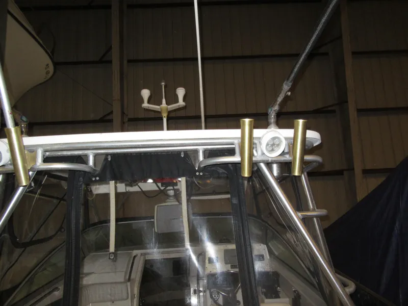 Slide: The Image of 2002 Boston Whaler 295 Conquest boat interior with rod holders and navigation equipment. - 16