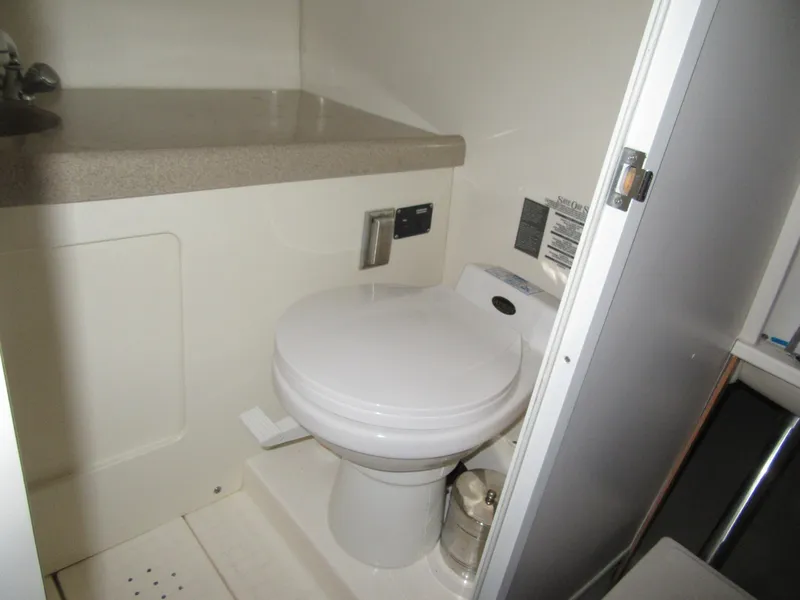 Slide: The Image of 2002 Boston Whaler 295 Conquest boat bathroom with toilet and sink. - 8