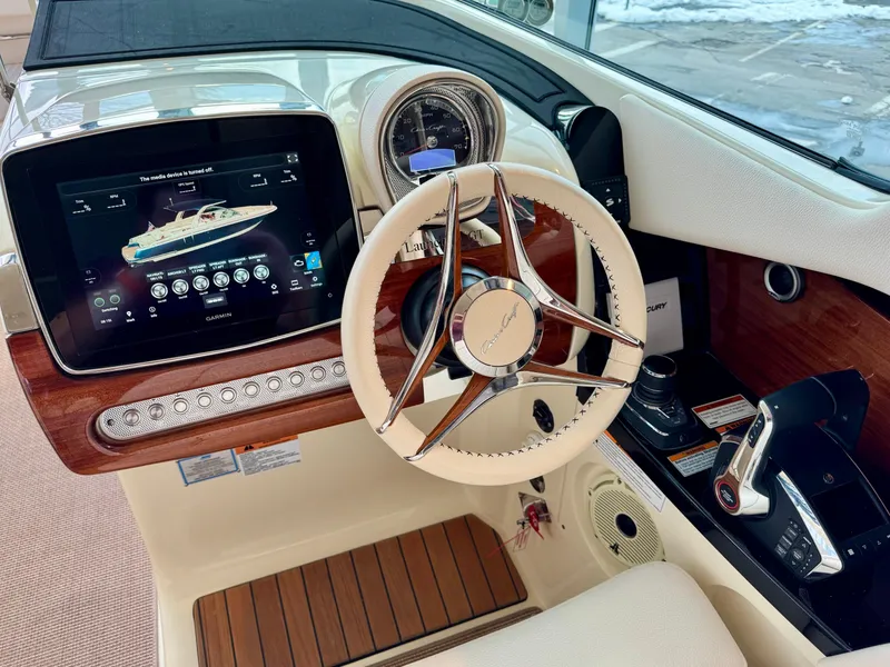 Slide: The Image of 2023 Chris-Craft Launch 31 GT dashboard with steering wheel and digital display. - 10