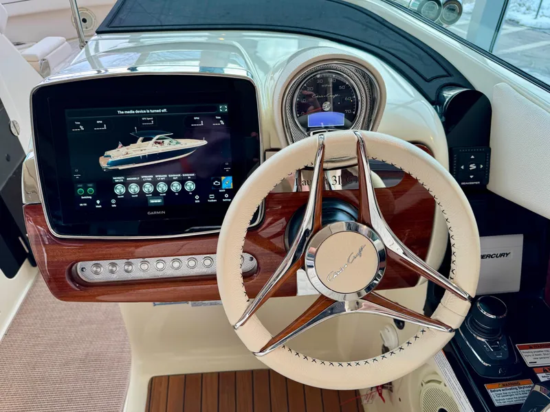 Slide: The Image of 2023 Chris-Craft Launch 31 GT dashboard with steering wheel and digital display. - 11