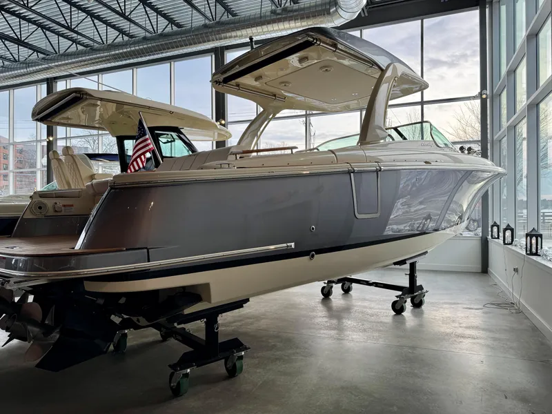 Slide: The Image of 2023 Chris-Craft Launch 31 GT boat displayed indoors, side view. - 2