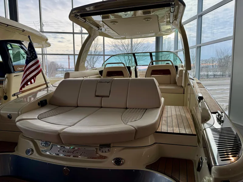 Slide: The Image of 2023 Chris-Craft Launch 31 GT boat with elegant seating and sleek design in a showroom. - 3