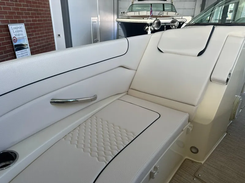 Slide: The Image of 2024 Chris-Craft Launch 28 GT interior seating with white upholstery and diamond stitching. - 19