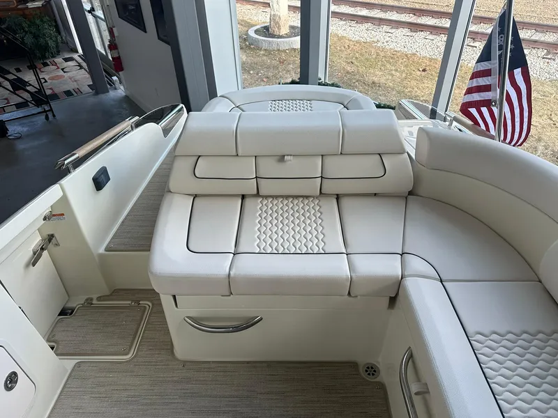 Slide: The Image of 2024 Chris-Craft Launch 28 GT boat interior with white cushioned seating. - 26