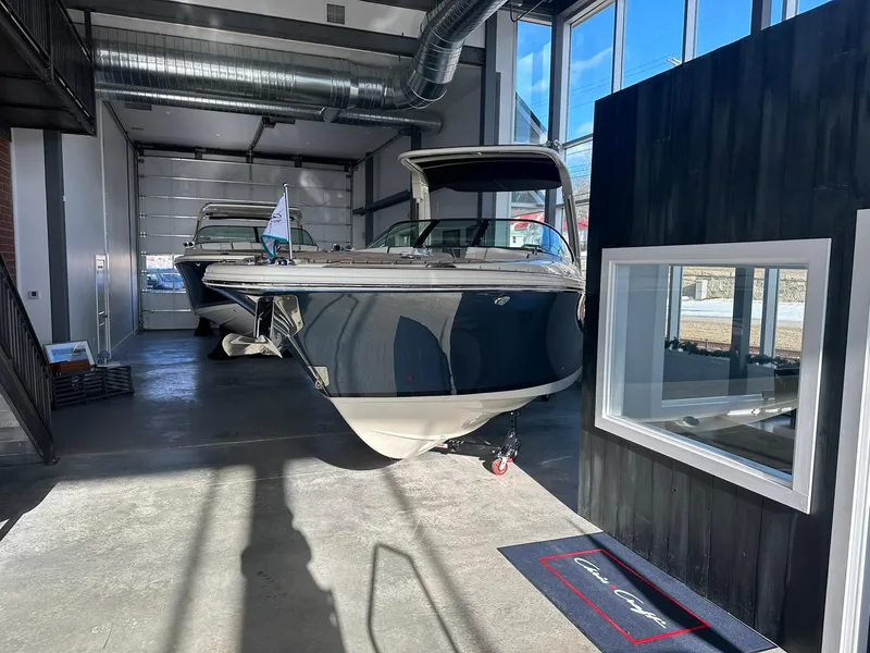 Slide: The Image of 2024 Chris-Craft Launch 28 GT boat displayed in a showroom. - 3