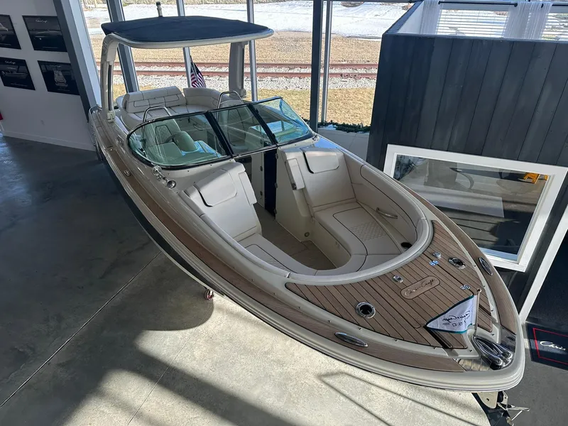 Slide: The Image of 2024 Chris-Craft Launch 28 GT boat displayed indoors with elegant seating and sleek design. - 4