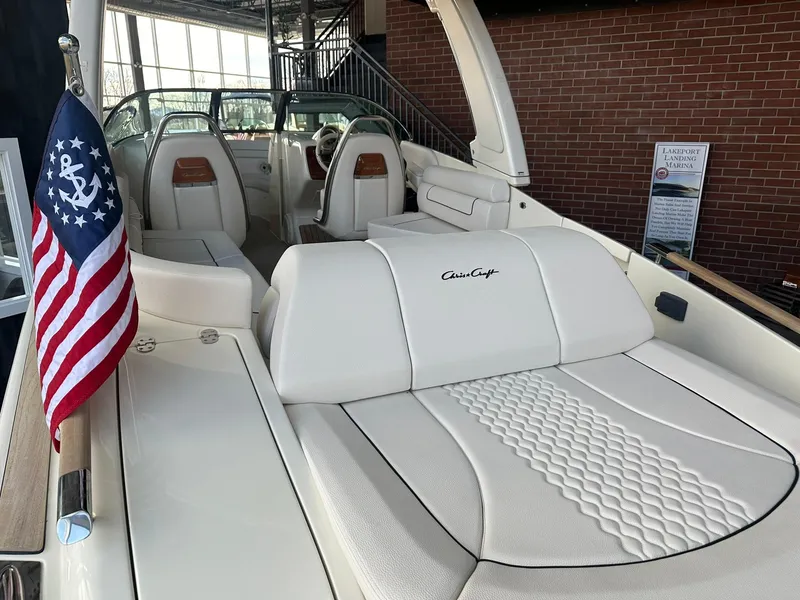 Slide: The Image of 2024 Chris-Craft Launch 28 GT boat interior with white leather seats and American flag. - 6