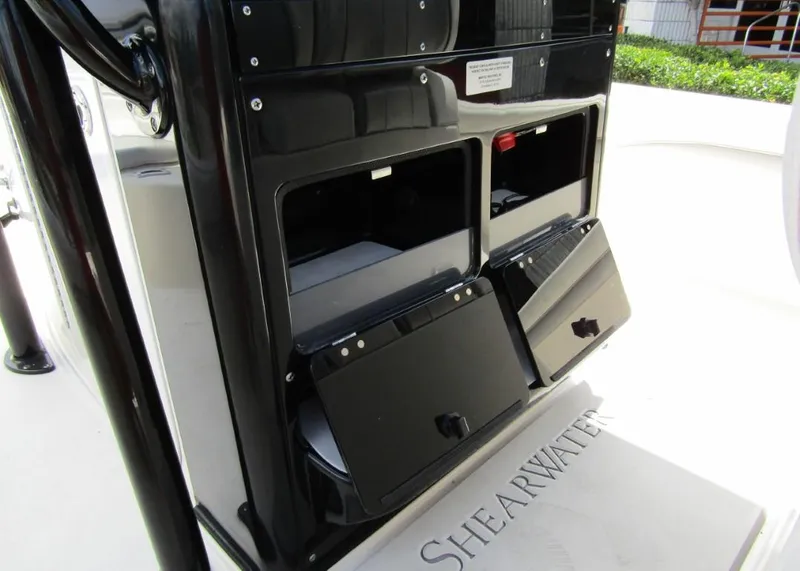 Slide: The Image of 2021 ShearWater 250 Carolina Bay storage compartments and console. - 19