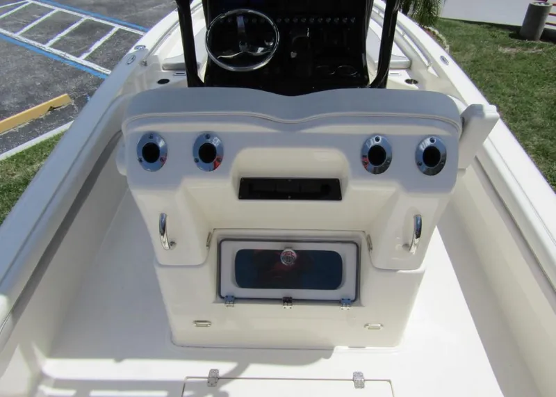 Slide: The Image of 2021 ShearWater 250 Carolina Bay boat console with steering wheel and storage compartments. - 20