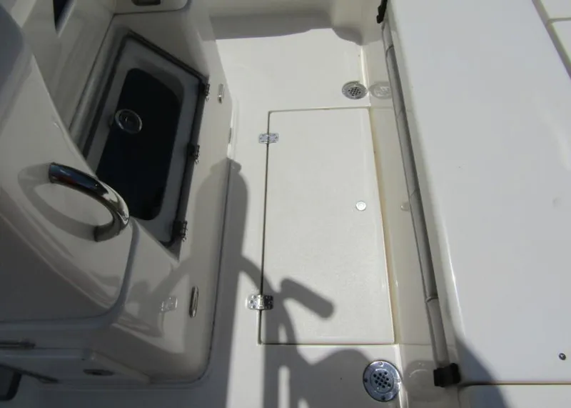 Slide: The Image of 2021 ShearWater 250 Carolina Bay boat deck with storage compartments and drainage. - 21