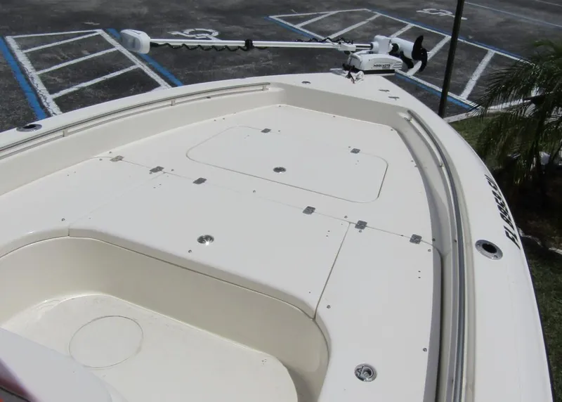Slide: The Image of 2021 ShearWater 250 Carolina Bay boat deck with storage compartments and trolling motor. - 7