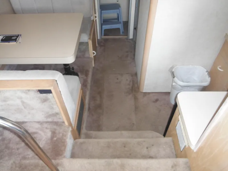 Slide: The Image of Interior of 1990 Silverton 34 Convertible boat with dining area and steps. - 10